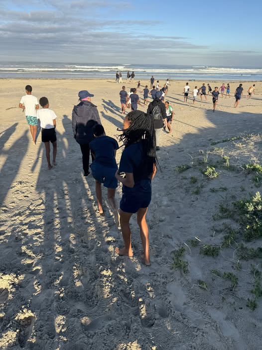 May be an image of 12 people and beach