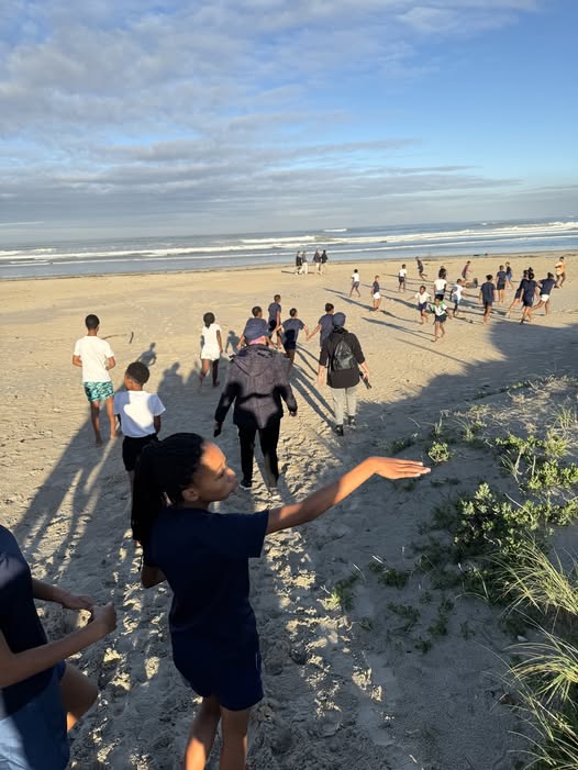 May be an image of 9 people and beach