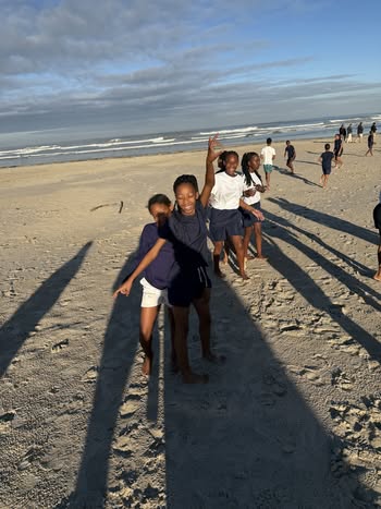 May be an image of 11 people, beach and ocean